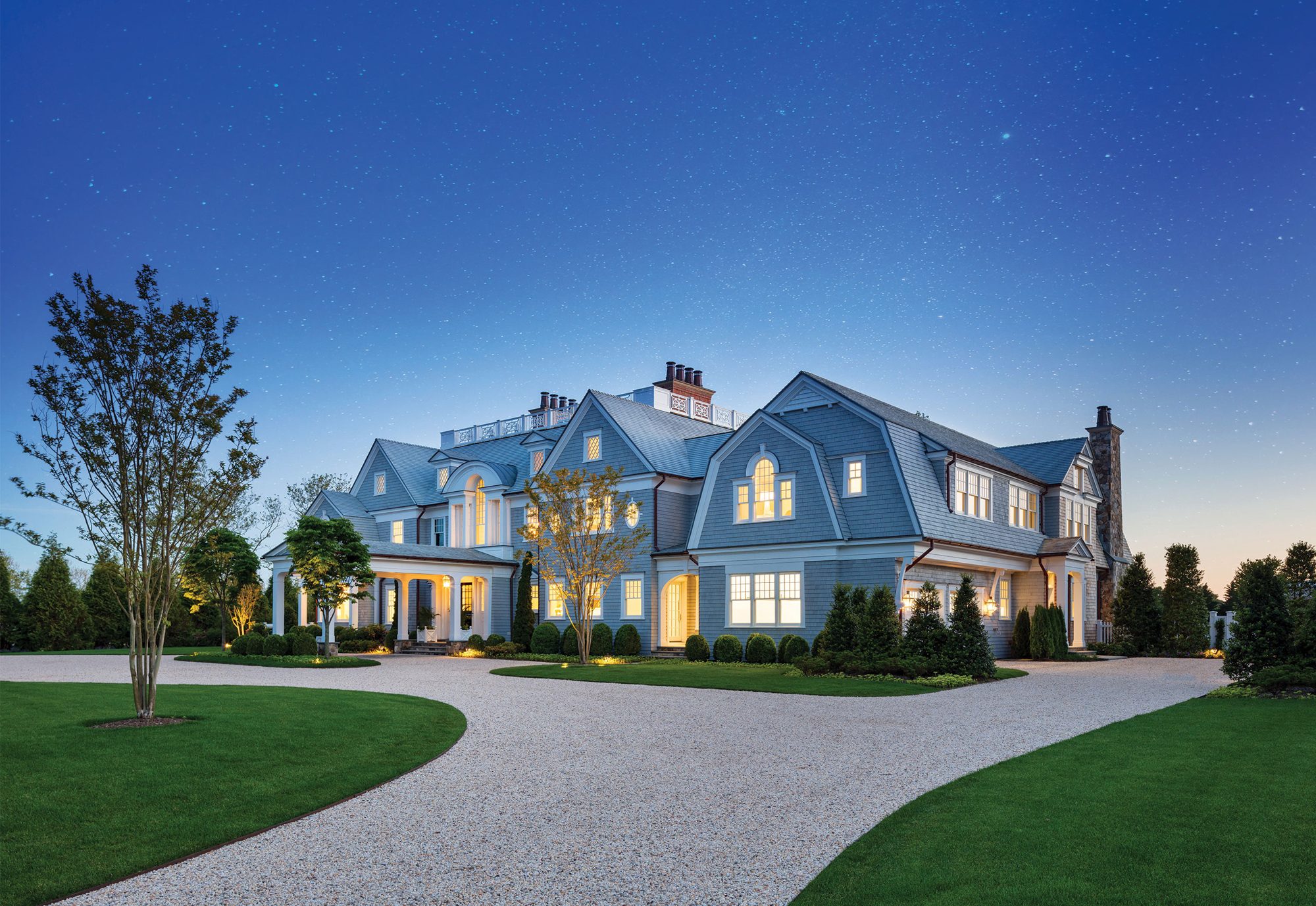 A house glowing with warm light in the dusk
